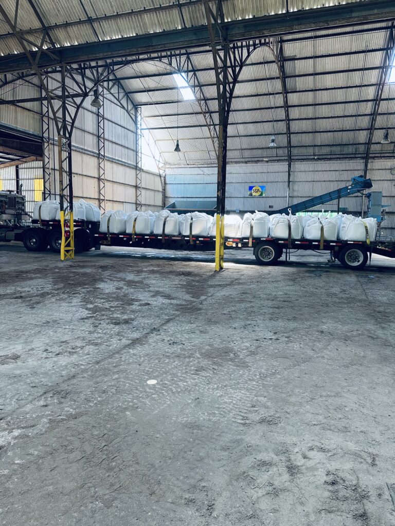 A truck with many white buckets on it