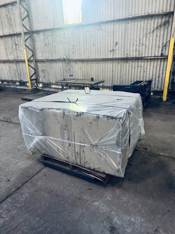 A large box wrapped in plastic and sitting on top of a pallet.